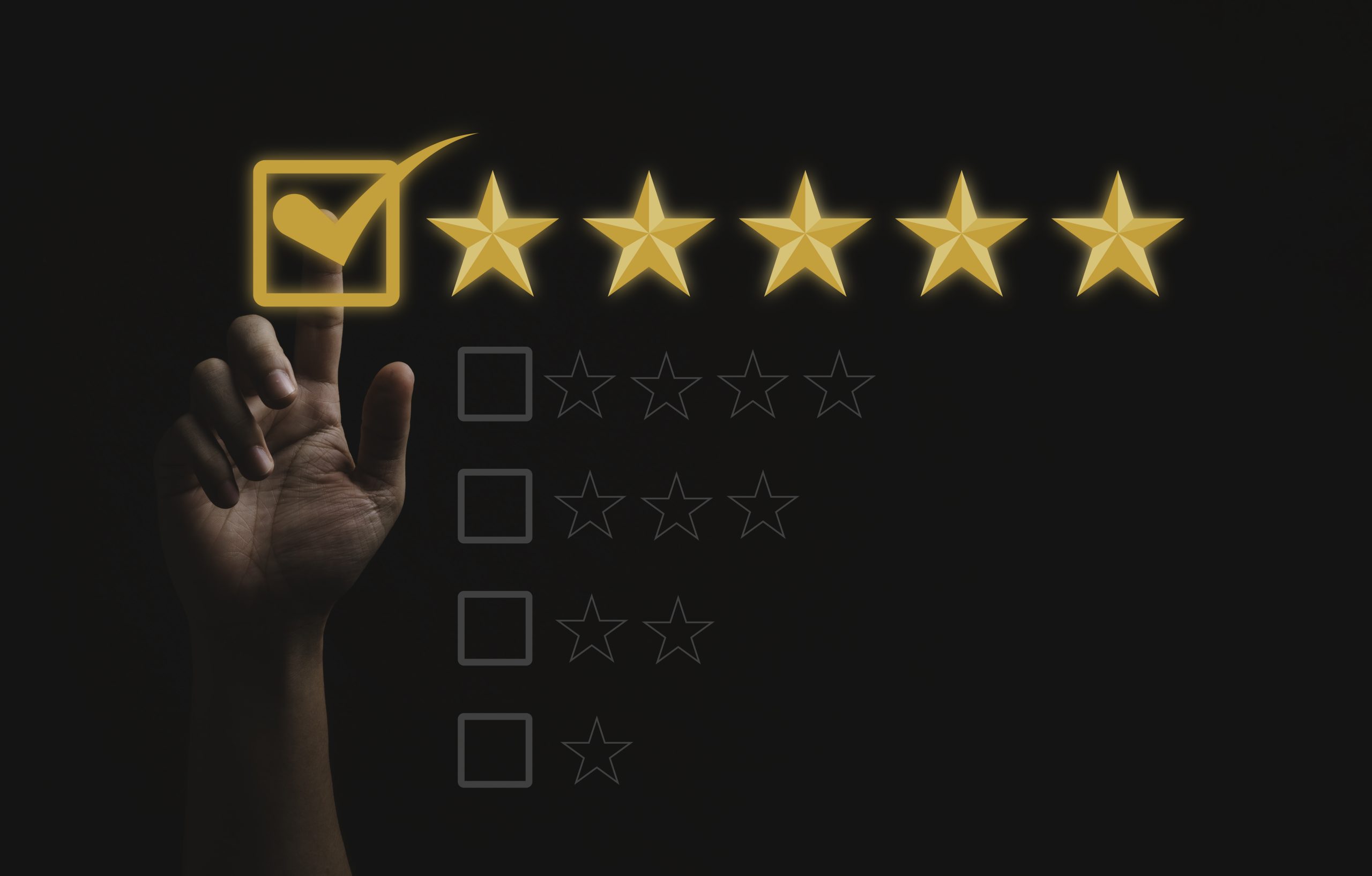 hand ticking a box with five yellow stars